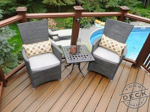 Stunning Trex deck overlooking a pool surrounded by landscaping.